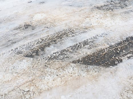 Snow, ice, slush and winter mud at a pedestrian crossing. The air temperature is about 0. Difficult driving conditions. Braking distance of the car. Traffic Laws. Infrastructure and road services.