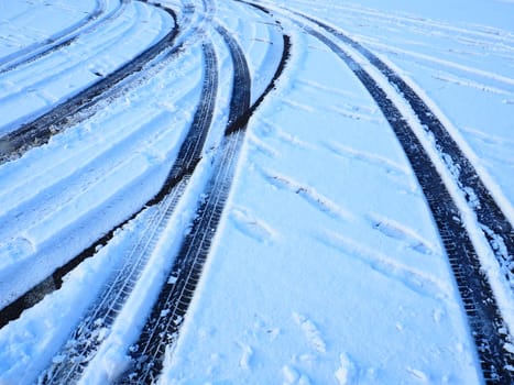 Snowdrifts on the side of the road. Bad weather and traffic. Snow on asphalt. Difficult driving conditions. Winter slosh on the road. Braking distance of a car