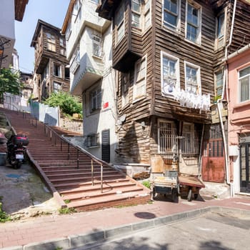 Beautiful old traditional wooden and stone houses, and stone staircase, in old Balat district, on a summer day, Istanbul, Turkey