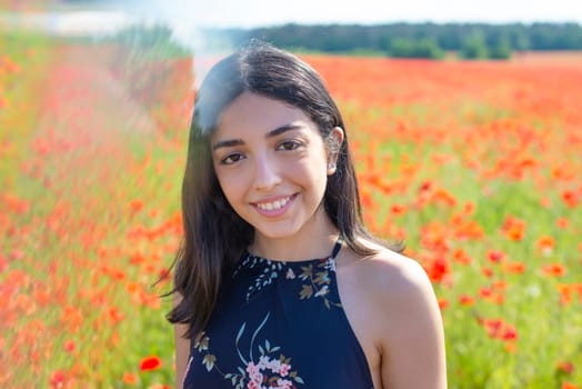 laughing young woman in poppy field