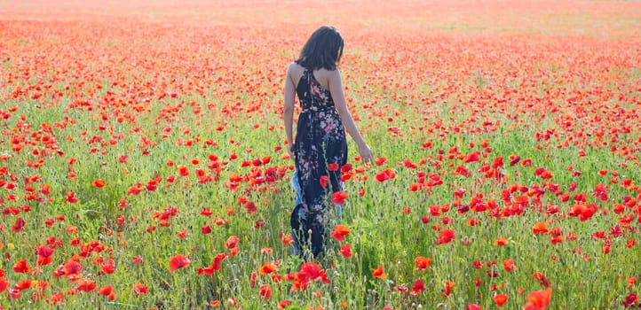 melancholic young woman in poppy field
