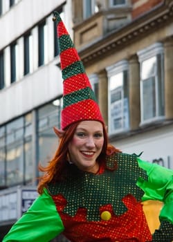 London, United Kingdom - December 2nd, 2006: Unknown woman dressed in Christmas elf costume posing for tourists during "Oxford Street closed for traffic"" event."