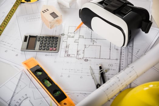 Architect workplace top view. Architectural blueprint paper project plans on desk table, tool for engineer contractor building design working drawing and VR glasses, industry virtual technology