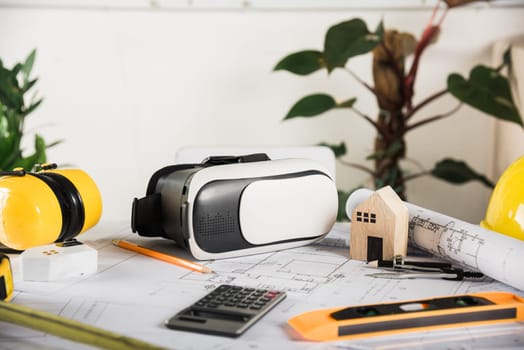 Architect workplace top view. Architectural blueprint paper project plans on desk table, tool for engineer contractor building design working drawing and VR glasses, industry virtual technology