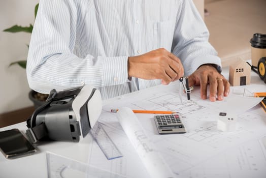 Architect workplace. Architectural building design and construction plans with blueprints paper project plans and VR glasses, designing man edit a building or architecture drawing with compass divider