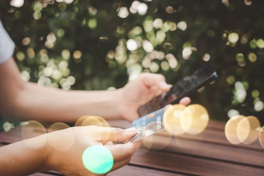Close up hand of woman using credit card and smartphone during slide screen for finding product purchase buying payments online shopping, making secure internet payment browsing banking service