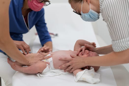 Baby beeing vaccinated by pediatrician in presence of his mother. Preventive vaccination against Diphtheria, whooping cough, tetanus, hepatitis, haemophilus influenzae, pneumococcus, poliomyelitis.