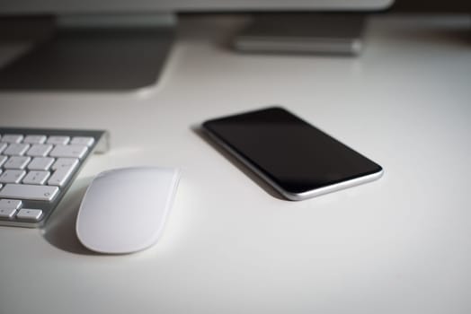 Desktop monitor with a wireless keyboard, mouse, dvd drive and a smartphone