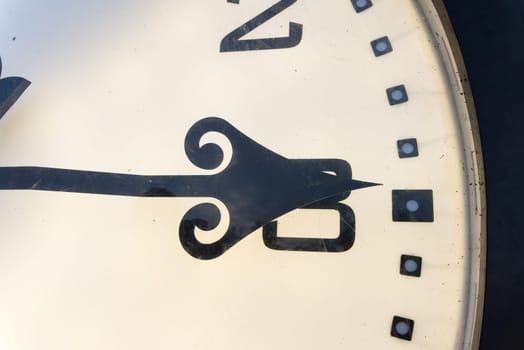 Particular of a clock in a park in the city