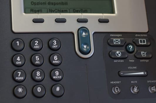 a phone in the office with dial buttons