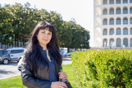portrait of an ukrainian girl visiting Rome, palace of civilization and work as background