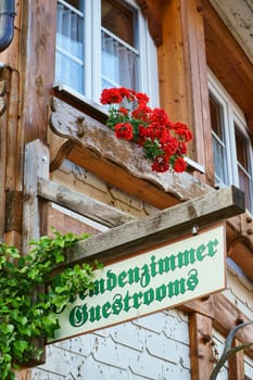 Wooden sign stranger's room - Guestrooms on house wall