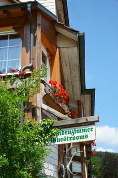 Wooden sign stranger's room - Guestrooms on house wall