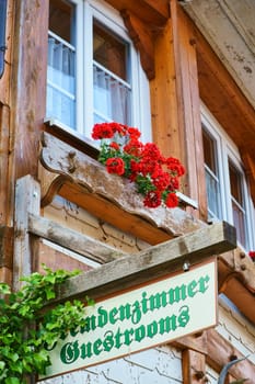 Wooden sign stranger's room - Guestrooms on house wall