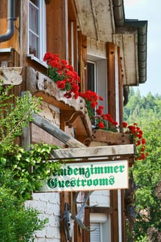 Wooden sign stranger's room - Guestrooms on house wall