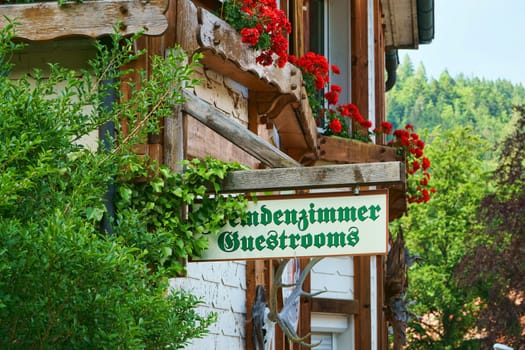 Wooden sign stranger's room - Guestrooms on house wall