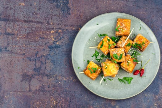 Roasted tofu cheese on sticks. Vegetarian food, space for text