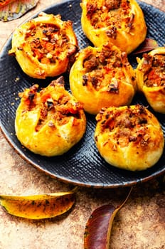Sweet buns with nuts on the plate. Fall sweets, autumn dessert