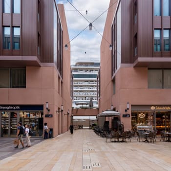 Istanbul, Turkey - August 31, 2022: Internal passage at Galataport, a mixed use development located along shore of Bosphorus strait, in Karakoy district, with docked huge cruise ship in the background