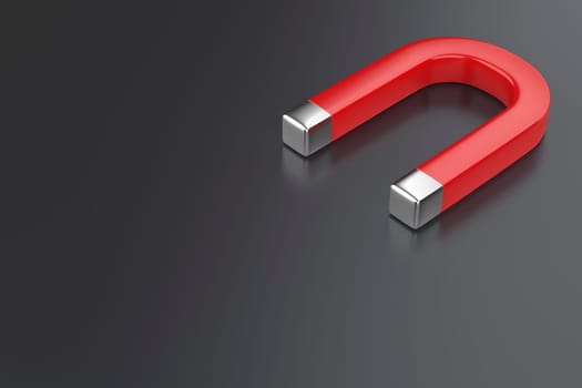 Red horseshoe magnet on dark grey background