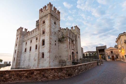 Sirmione, Italy - June 2022: Sirmione castle on Garda lake. Scenic mediaeval building on the water