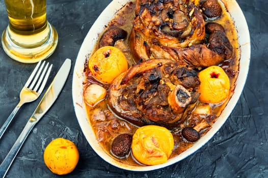 Roasted pork knuckle eisbein with cabbage and apples. Pork leg, German food