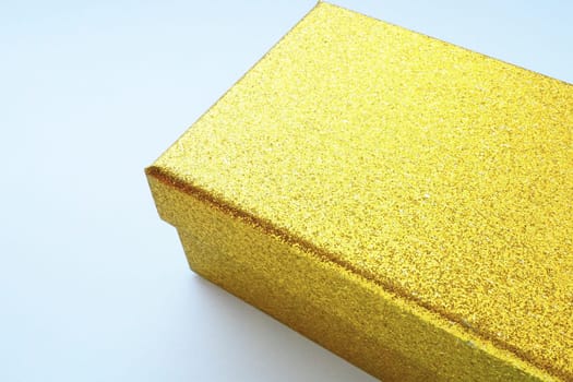 Golden gift box on white background. Decorative surprise box. Copy space.