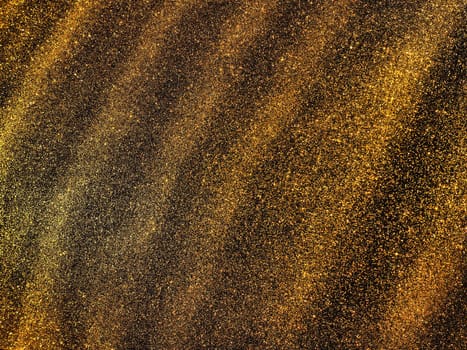 Bokeh light of gold glitters. Golden glitter texture background. Sparkling glitter wrapping paper with sequins and sparkles. Festive golden bokeh and glitter. Diagonal stripes and waves.