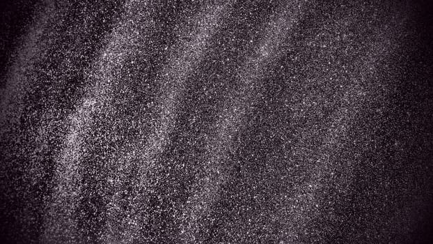 Bokeh light of silver glitters on black background. Sparkling glitter wrapping paper with sequins and sparkles. Festive white bokeh. Diagonal stripes and waves.