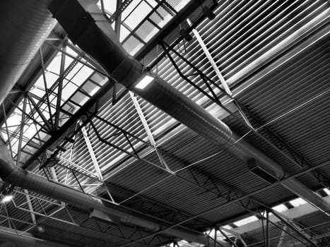 The roof of a hangar, a production hall or a sports hall. Metal structures, beams, supporting elements. Ventilation systems in large halls and rooms. Skylights. Industrial interior