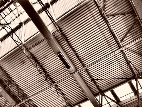 The roof of a hangar, a production hall or a sports hall. Metal structures, beams, supporting elements. Ventilation systems in large halls and rooms. Skylights. Industrial interior