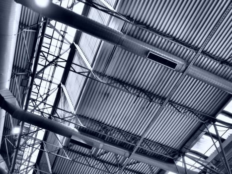 The roof of a hangar, a production hall or a sports hall. Metal structures, beams, supporting elements. Ventilation systems in large halls and rooms. Skylights. Industrial interior