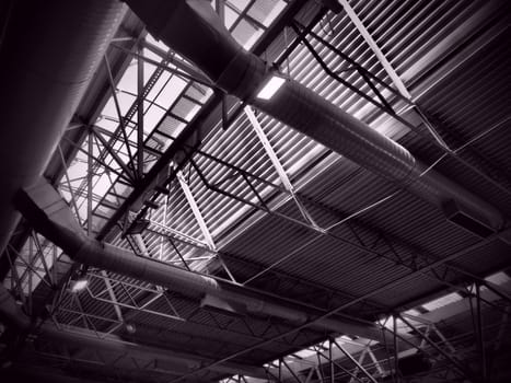 The roof of a hangar, a production hall or a sports hall. Metal structures, beams, supporting elements. Ventilation systems in large halls and rooms. Skylights. Industrial interior