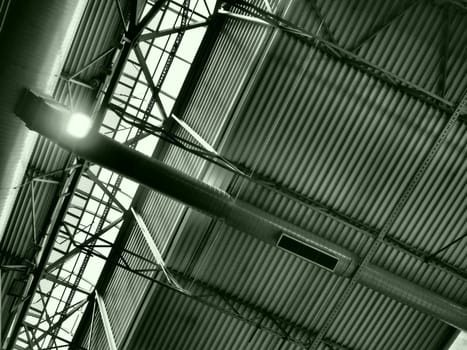 The roof of a hangar, a production hall or a sports hall. Metal structures, beams, supporting elements. Ventilation systems in large halls and rooms. Skylights. Industrial interior