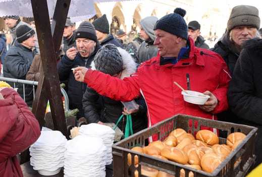 Krakow, Poland - Dec 18, 2022: Christmas Eve for poor and homeless on the Main Square in Cracow. The group Kosciuszko prepares the greatest eve in the open air in Krakow