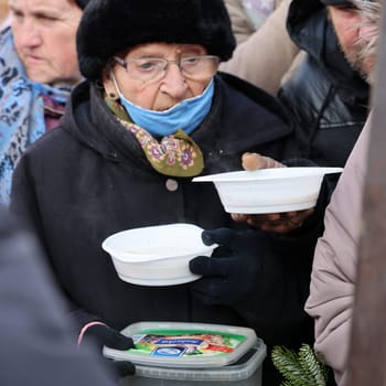 Krakow, Poland - Dec 18, 2022: Christmas Eve for poor and homeless on the Main Square in Cracow. The group Kosciuszko prepares the greatest eve in the open air in Krakow