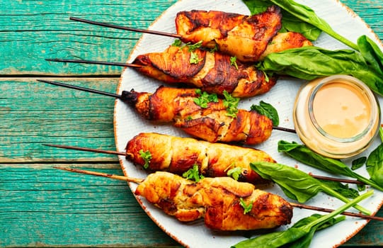 Appetizing chicken meat, chicken breast roasted on wooden skewers. Kebabs on cutting board