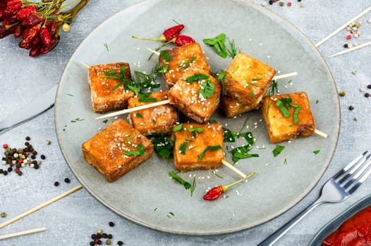 Grilled tofu cheese skewers on the plate. Healthy food