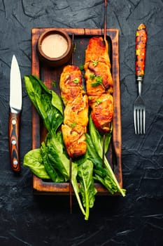 Appetizing chicken meat, chicken breast roasted on wooden skewers. Kebabs on cutting board