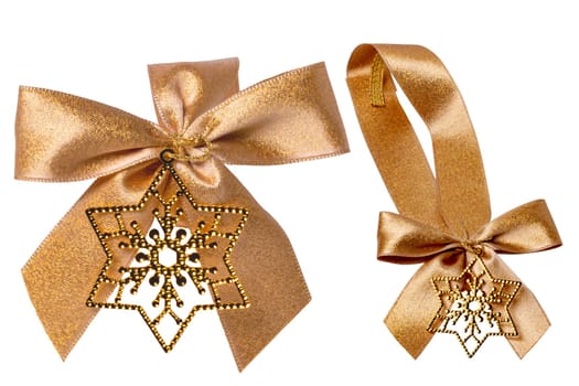 Gift bows. Closeup of a decorative golden ribbon bow made of silk for gift box isolated. Decorations background with star. Clipping path. Two views.