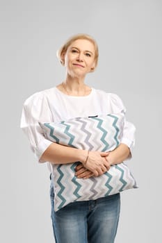 Senior woman hugs soft pillow