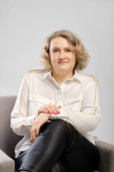 Studio portrait ofconfident senior woman in white shirt with crossed arms