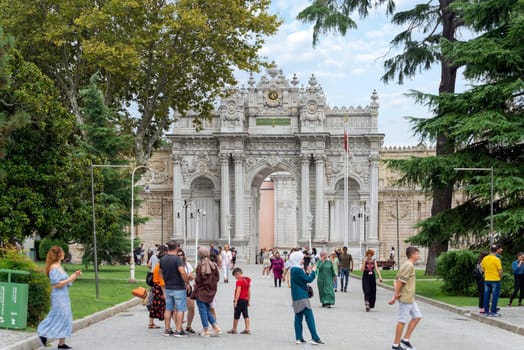 Istanbul, Turkey - August 31, 2022: Entrance of Dolmabahce Palace, with tourists visiting the place