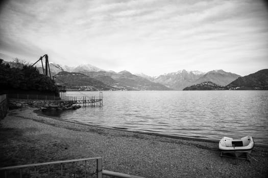 Lake view with boat on the beach, landscape view, black and white