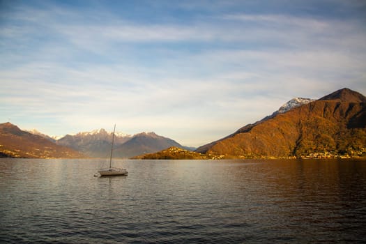 Lonely boat in a lake, sunset light, horizontal view