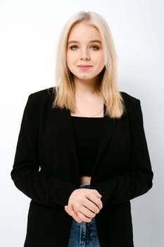 Portrait of cute teenager girl in tank top, jacket and jeans