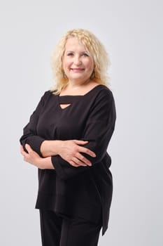 Portrait of cheerful and confident senior woman in black clothes