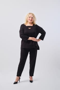 Full length studio portrait of cheerful and confident senior woman