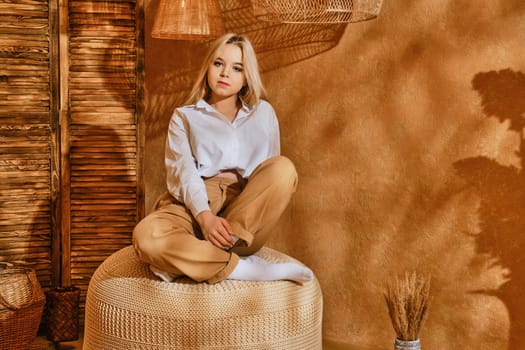 Teenager girl sit on a padded stool in relaxing environment.