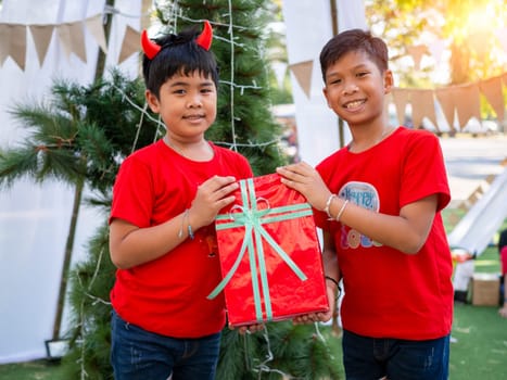 Boy holding presents on Christmas celebration.Christmas festival.